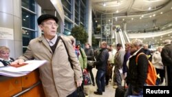 Passengers, whose flights to Egypt were suspended, gather at an information desk of Domodedovo airport outside Moscow, Russia, Nov. 6, 2015.