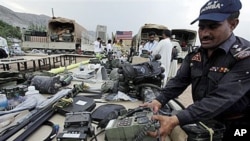 A Pakistani officer in Peshawar arranges recovered equipment that has been stolen in recent months from NATO forces fighting in neighboring Afghanistan, 27 Sep 2010