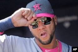 FILE - The Houston Astros' Yuli Gurriel wears stickers on his face reading "love" and "mama" during the first inning of a baseball game on Mother's Day at Yankee Stadium against the New York Yankees, May 14, 2017, in New York.