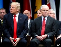FILE - President Donald Trump and Attorney General Jeff Sessions attend the FBI National Academy graduation ceremony in Quantico, Va., Dec. 15, 2017.
