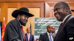 FILE - South Sudan's President Salva Kiir, left, and opposition leader Riek Machar, right, shake hands during peace talks in Addis Ababa, Ethiopia, June 21, 2018.