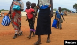 FILE - A South Sudan refugee family arrives at the UNHCR managed refugees reception point at Elegu, within Amuru district of the northern region near the South Sudan-Uganda border, Aug. 20, 2016.