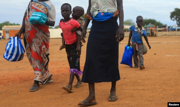 FILE - A South Sudan refugee family arrives at the UNHCR managed refugees reception point at Elegu, within Amuru district of the northern region near the South Sudan-Uganda border, Aug. 20, 2016.