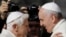 FILE—In this Sunday, Sept. 28, 2014 file photo, Pope Francis, right, hugs Emeritus Pope Benedict XVI prior to the start of a meeting with elderly faithful in St. Peter's Square at the Vatican.
