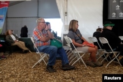 A group of people sit and watch a presentation on agricultural economics at the 2018 Farm Progress Show in Boone, Iowa, U.S., August 29, 2018. Picture taken on August 29, 2018. REUTERS/Jordan Gale