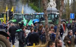 Farmers and tractors gather outside of an EU summit in Brussels, Feb. 20, 2020. Baltic farmers on Thursday were calling for a fair allocation of direct payments under the European Union's Common Agricultural Policy