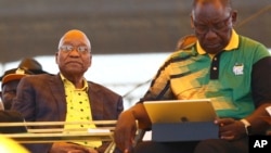 Newly-elected ruling African National Congress (ANC) party president, Cyril Ramaphosa, right, and former ANC president and South African President Jacob Zuma, left, attend the party's 106th birthday celebrations in East London, South Africa, Jan. 13, 2018.