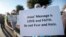 A woman who asked not to be identified holds a sign as she joins hundreds of supporters outside the Curtis Culwell Center where a Muslim conference against terror and hate was scheduled, Jan. 17, 2015, in Garland, Texas.