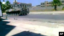 Image taken from video footage uploaded on YouTube shows a Syrian army tank deployed in a main street in the Khalidiya area of the protest hub of Homs, 160 kilometers north of Damascus, on August 17, 2011.