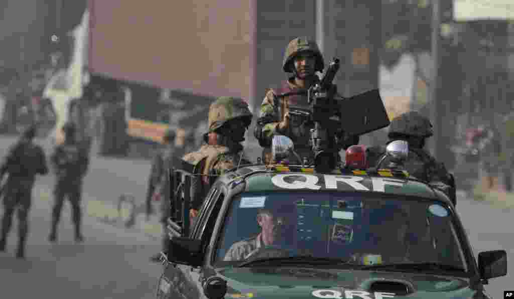 Army troops secure a road leading to the site of a suicide bombing in Rawalpindi, Pakistan, Jan. 20, 2014.