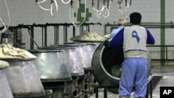 FILE - Iranian prisoners work in a kitchen in the Evin prison, Tehran.