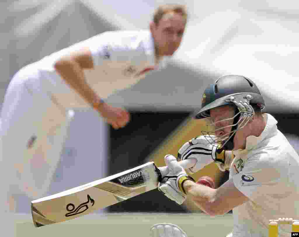 Australia's Chris Rogers, right, is struck on the head off the bowling of England's Stuart Broad, left, during their Ashes cricket test match at the Melbourne Cricket Ground in Melbourne.