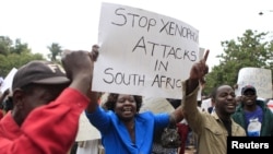 FILE: Zimbabweans rally against recent anti-immigrant violence in South Africa, outside the South African embassy in Harare, April 17, 2015.