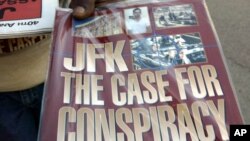 FILE - A vendor displays a booklet alleging a conspiracy was behind the assassination of President John F. Kennedy in downtown Dallas, Saturday, Nov. 8, 2003.