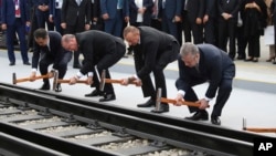 Turkey's President Recep Tayyip Erdogan, 2nd left, Azerbaijan's President Ilham Aliyev, 2nd right and Georgia's Prime Minister Giorgi Kvirikashvili, right, inaugurate the Baku-Tbilisi-Kars railway, at a ceremony in Baku, Azerbaijan, Oct. 30, 2017. 