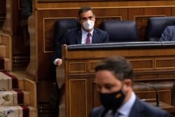 FILE - Santiago Abascal, leader of Spain's far-right party Vox, walks to give his speech as Prime Minister Pedro Sanchez looks on during a no-confidence motion against the government at parliament in Madrid, Spain, October 22, 2020.