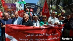 FILE— Protest demanding the release of imprisoned journalists, activists, opposition figures and setting a date for fair presidential elections in Tunis, Tunisia May 12, 2024.