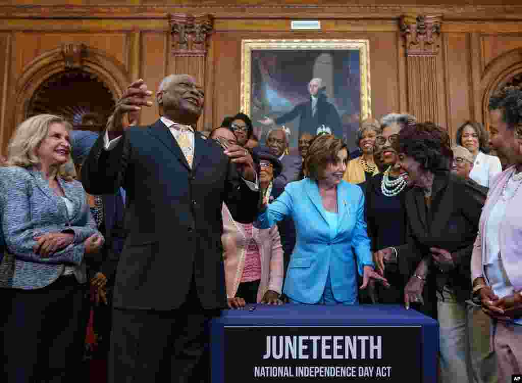 House Majority Whip James Clyburn, D-S.C., left, celebrates with Speaker of the House Nancy Pelosi and members of the Congressional Black Caucus after passage of the Juneteenth National Independence Day Act at the Capitol in Washington.