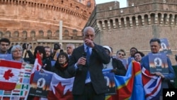 FILE - Sex-abuse survivor Peter Isely of the U.S.-founded Ending Clergy Abuse organization, speaks during a twilight vigil prayer near Castle Sant' Angelo, in Rome, Feb. 21, 2019.