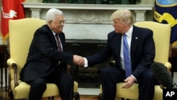 FILE - President Donald Trump shakes hands with with Palestinian leader Mahmoud Abbas during their meeting in the Oval Office of the White House, May 3, 2017, in Washington. 