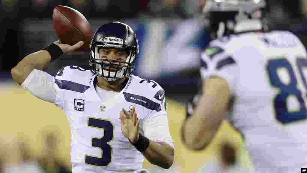 Seattle Seahawks&#39; Russell Wilson looks to pass against the Denver Broncos during the first half of the NFL Super Bowl XLVIII football game.