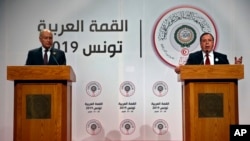 Tunisian Foreign Minister Khemaies Jhinaoui, right, speaks during a joint press conference with Arab League Secretary-General, Ahmed Aboul Gheit, at the end of the Arab Summit, in Tunis, Tunisia, Sunday, March 31, 2019. 