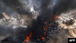 Bomberos palestinos apagan un gran incendio en la fábrica de colchones Foamco al este de Jabalia en el norte de la Franja de Gaza, el 17 de mayo de 2021.