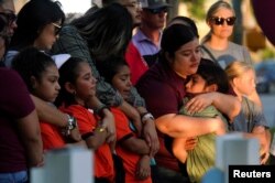 People mourn victims of the Robb Elementary School mass shooting, in Uvalde, Texas