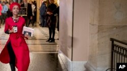 Rep. Ilhan Omar, Democrat-Minnesota, center, walks through the halls of the Capitol Building in Washington, Jan. 16, 2019.