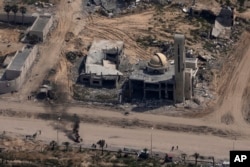 FILE—Destroyed buildings are seen through a window of an airplane from the U.S. Air force overflying the Gaza Strip, March 14, 2024.