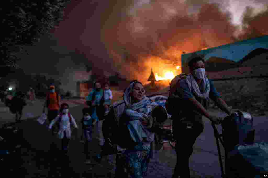 Migrants flee from the Moria refugee camp during a second fire, on the northeastern Aegean island of Lesbos, Greece.
