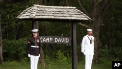 Members of an honor guard stand at attention at Camp David, Md. (file photo).