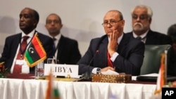 Libyan Foreign Minister Mohamed Abdelaziz, second left, attends a Cairo gathering of foreign ministers of Libya's neighbors in Cairo, Aug. 25, 2014. 