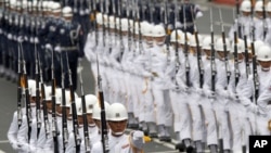 Military honor guards perform during Taiwan's National Day celebrations in front of the Presidential Office in Taipei, October 10, 2011.