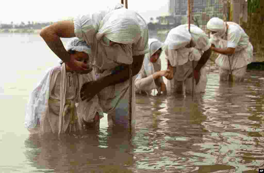 Followers of the Sabean Mandaeans, a pre-Christian sect that follows the teachings of John the Baptist, perform their rituals in the Tigris river during a celebration marking &quot;Banja&quot; or Creation Feast in central Baghdad, Iraq.