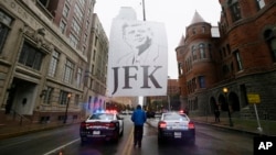 A man leaves the area after a ceremony to mark the 50th anniversary of the assassination of John F. Kennedy, at Dealey Plaza in Dallas, Nov. 22, 2013. President Kennedy's motorcade was passing through Dealey Plaza when shots rang out on Nov. 22, 1963.