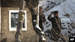 دوو سه‌ربازی کۆریای باکور له‌سه‌ر ناوچه‌یه‌کی سـنووری وڵاته‌که‌یان پاسه‌وانی ده‌که‌ن، شه‌ممه‌ 27 ی یازده‌ی 2010