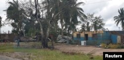 Damaged buildings are pictured from inside a vehicle after Cyclone Kenneth swept through the region in Cabo Delgado province, Mozambique, April 26, 2019, in this image obtained from social media.