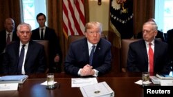 FILE - U.S. President Donald Trump speaks during a cabinet meeting, flanked by Secretary of State Rex Tillerson, left, and Secretary of Defense James Mattis, right, at the White House in Washington, Nov. 1, 2017.