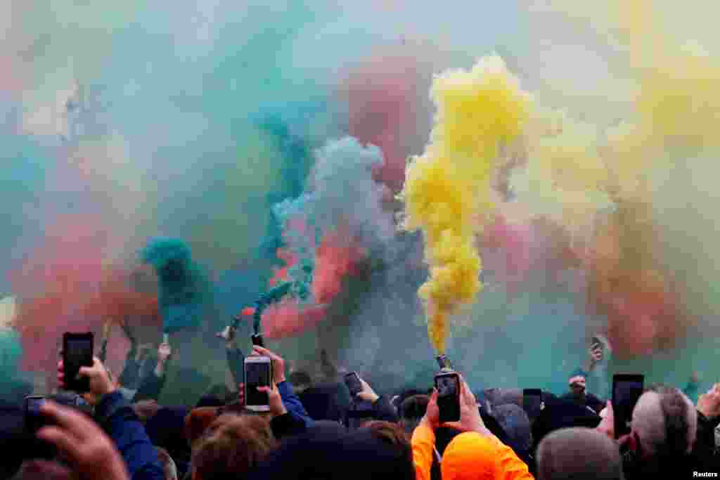 Manchester United fans with flares protest their owners outside the stadium before the Manchester United v. Liverpool match, at Old Trafford, Manchester, Britain.