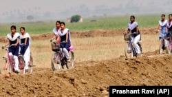 Indian schoolgirls ride bicycles, received under a Bihar government program of giving bicycles to teenage girls to keep them in school.