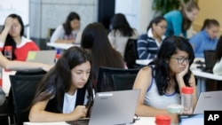 FILE - Students are seen completing an exercise at a Girls Who Code class in San Jose, California, June 18, 2014. Girls Who Code, a national non-profit, aims to prepare young women for futures in computing-related fields.