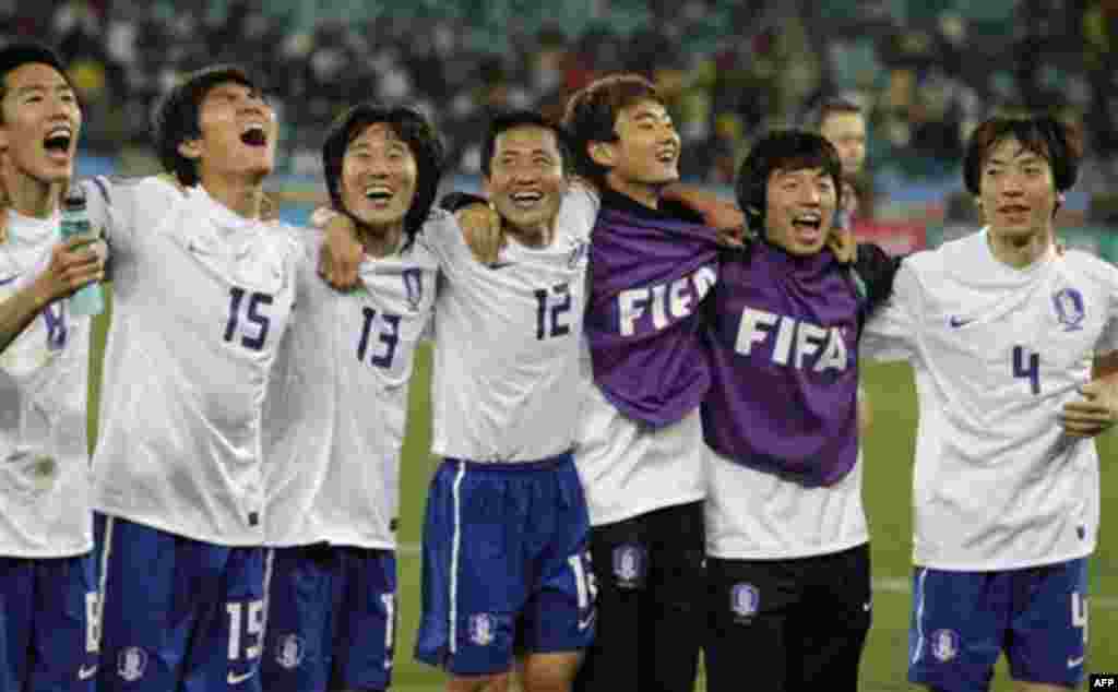 South Korea players celebrate following the World Cup group B soccer match between Nigeria and South Korea at the stadium in Durban, South Africa, Tuesday, June 22, 2010. The game ended in a 2-2 draw and Nigeria is out of the competition. (AP Photo/Schal