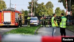 Rescue personnel work at the scene where a train struck a "cargo bicycle" popular with Dutch parents to transport their children at the city of Oss, Netherlands, Sept. 20, 2018. 