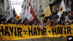 Activists march during a protest against the Turkish government's plans to build a nuclear power plant in the country in Istanbul March 19, 2011. The banner reads, "No no no."