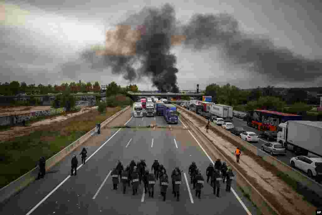 National police break up a crowd of pro-independence demonstrators blocking a major highway near Girona, Spain.