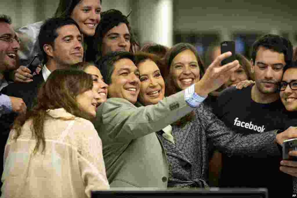 Facebook employees take a group selfie with Argentine President Cristina Fernandez, center, at the Facebook office in Buenos Aires, Argentina, May 6, 2014.