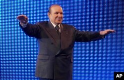 FILE - In this Feb. 12 2009, photo, Algerian President Abdelaziz Bouteflika waves during a rally in Algiers.