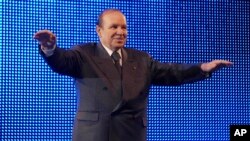 FILE - In this Feb.12 2009 photo, Algerian President Abdelaziz Bouteflika waves during a rally in Algiers.