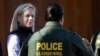 FILE - U.S. Department of Homeland Security Secretary Kirstjen Nielsen, left, speaks with Border Patrol agents near a newly fortified border wall structure, Oct. 26, 2018, in Calexico, Calif. 